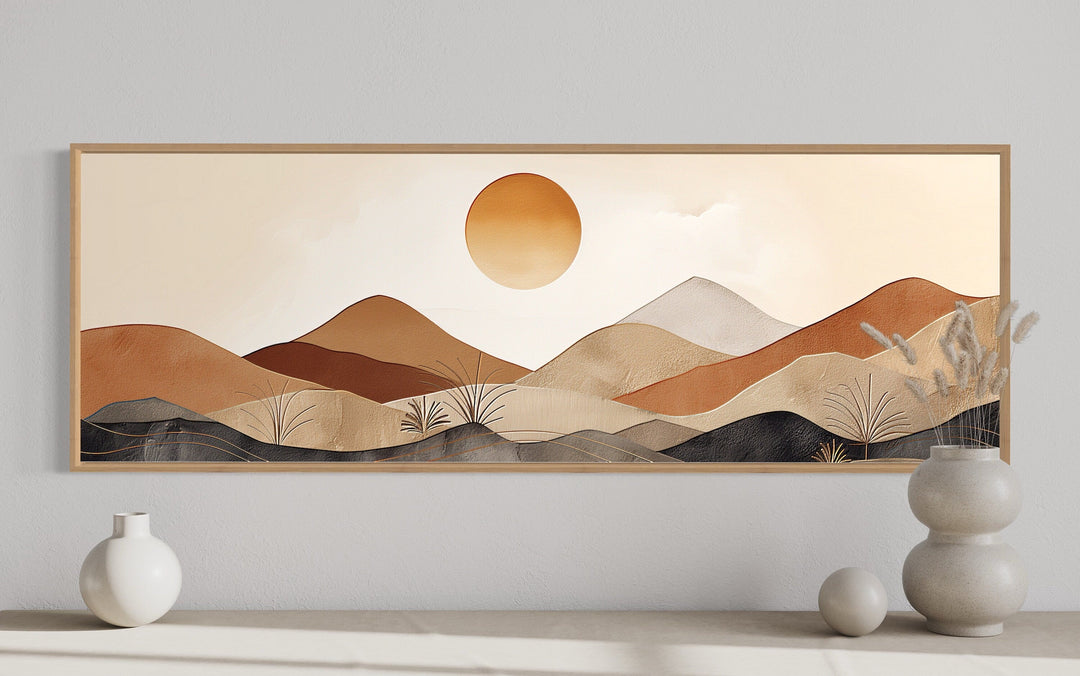 Long narrow canvas wall art featuring a mid-century modern neutral mountain landscape with a sun.