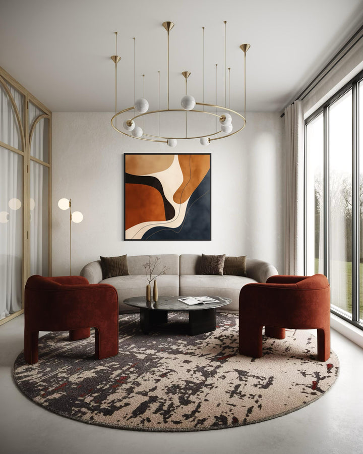 Square abstract canvas art with navy and earth-toned organic shapes above a modern sofa.