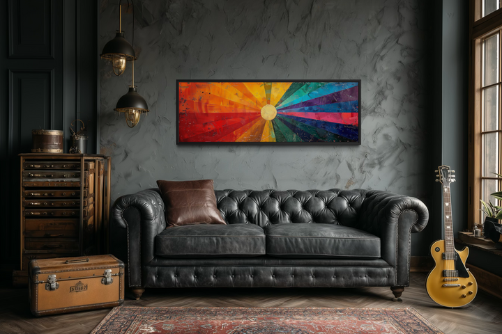 Mid Century Modern Sun Rays Panoramic Canvas Wall Art displayed above a black leather sofa.