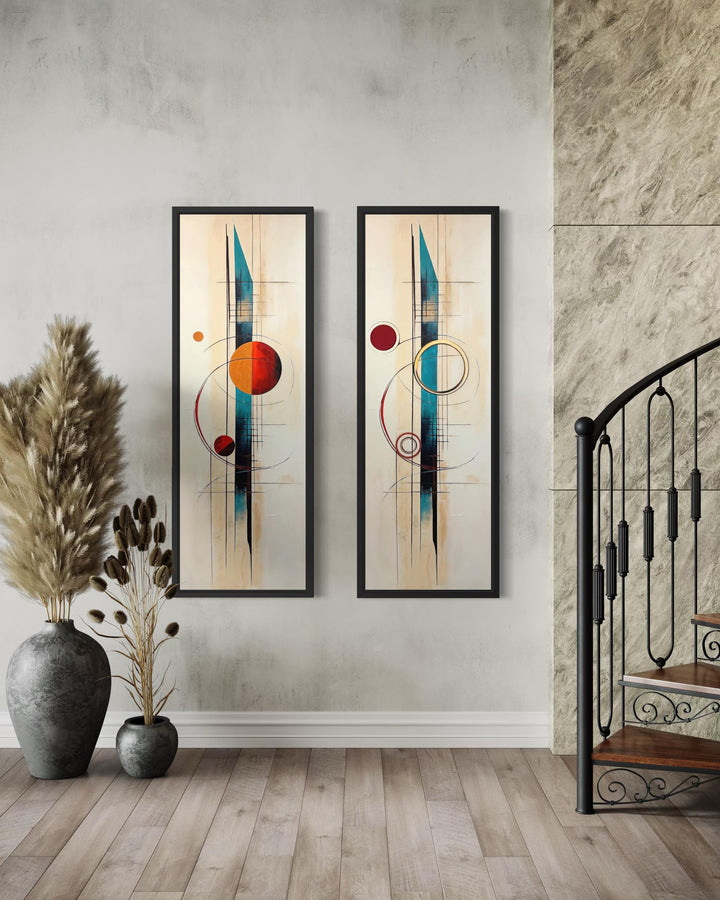 Two tall, narrow mid-century modern canvas prints with geometric shapes in teal, orange, and red.