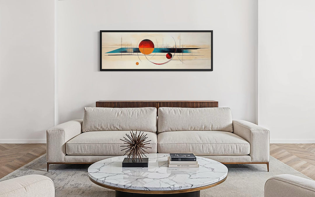 Mid century modern abstract canvas print with geometric shapes in a long horizontal black frame.