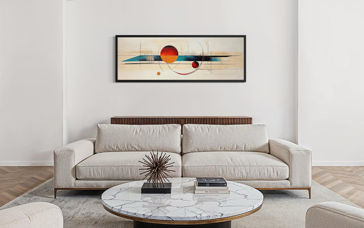 Mid century modern abstract canvas print with geometric shapes in a long horizontal black frame.