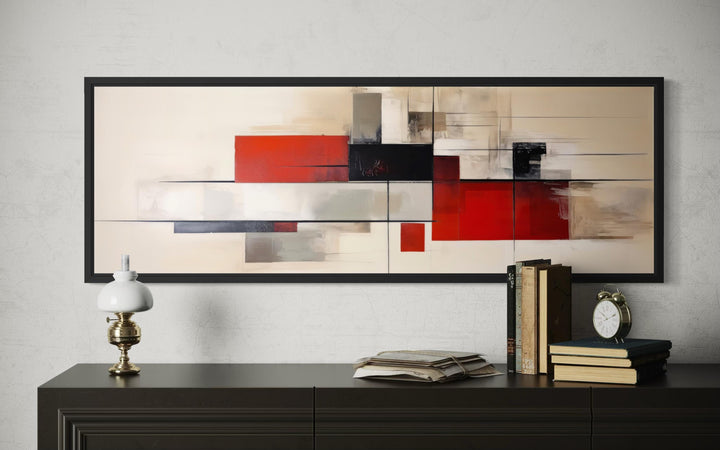 Large abstract geometric canvas print in red, beige, and black, framed above a dark wood sideboard.
