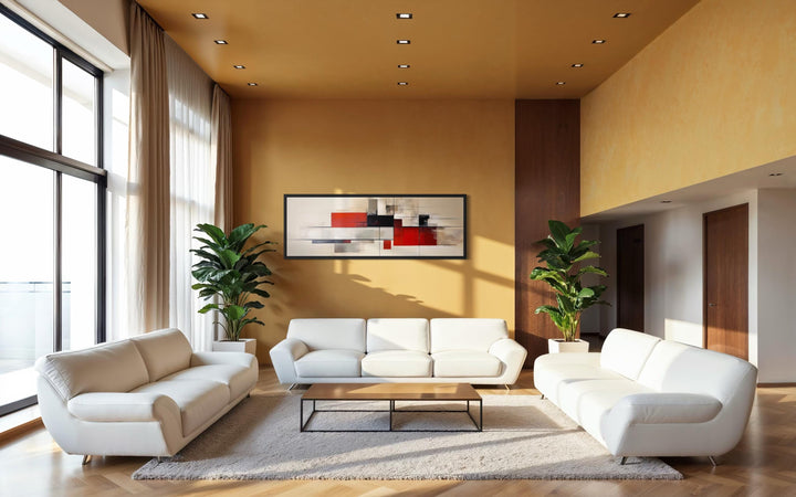 Large abstract geometric canvas print in red, beige, and black hanging in a modern living room.