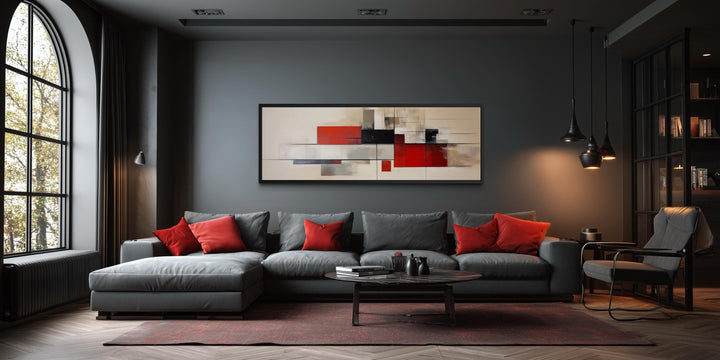 Large abstract canvas print with red, beige, and black geometric shapes in a modern living room.