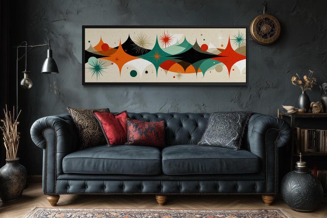 Mid Century Modern long horizontal canvas print with an atomic starburst design above a sofa.