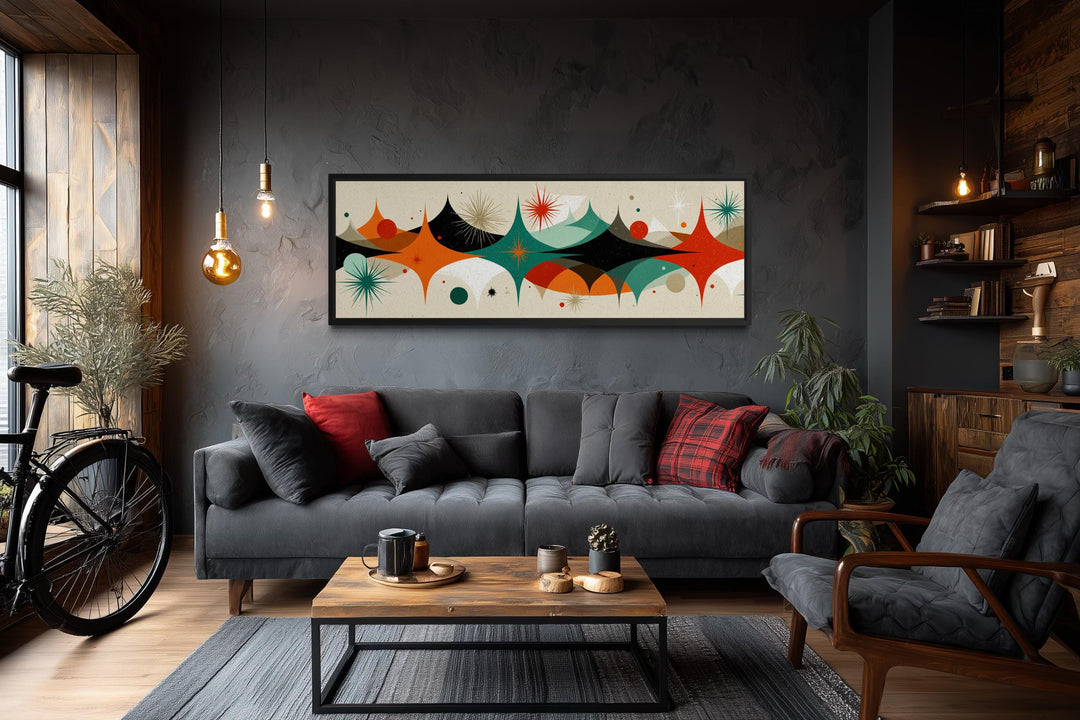 Mid century modern long horizontal canvas print with an atomic starburst design above a sofa.