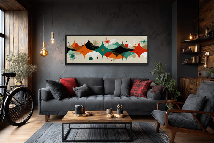 Mid century modern long horizontal canvas print with an atomic starburst design above a sofa.
