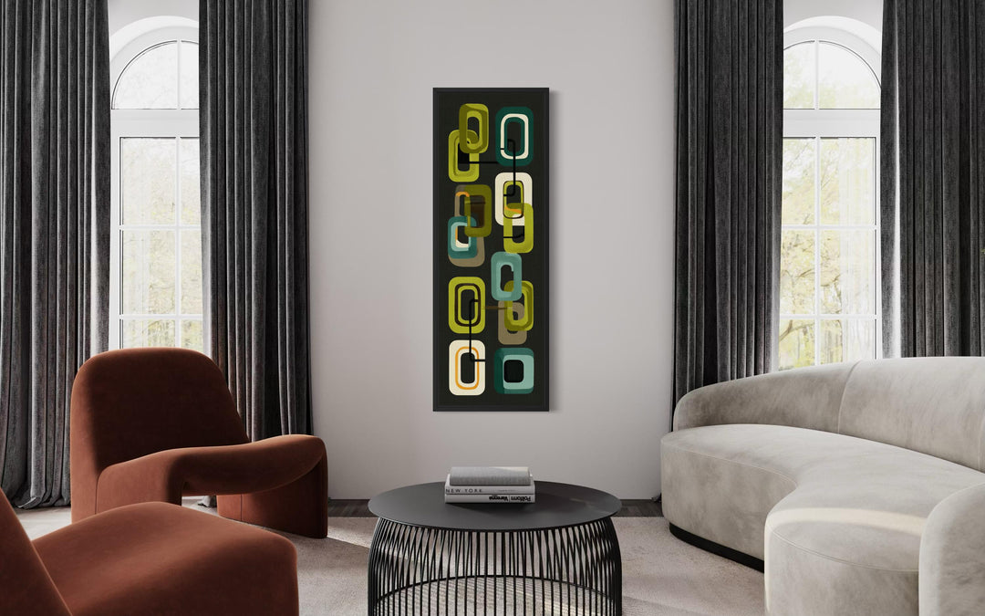 A vertical canvas print featuring retro green geometric shapes hangs in a modern living room.