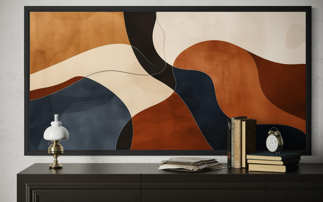 Mid Century abstract canvas print with curved shapes in rust, navy, and beige above a dark credenza.