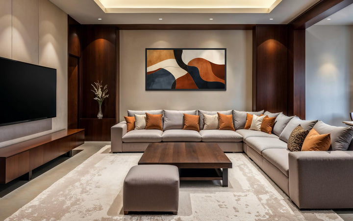Mid Century abstract canvas print with earth tones in brown, beige, and navy over a modern sofa.
