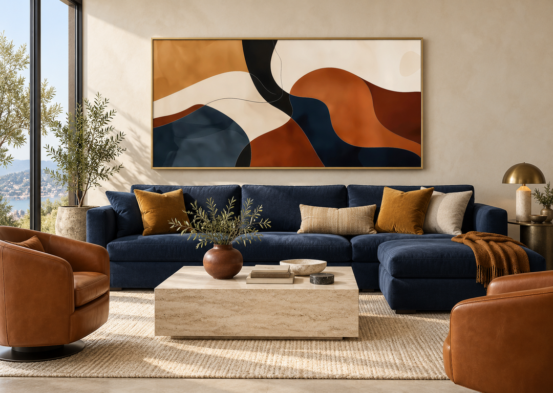 Large horizontal abstract canvas print with curved shapes in rust, navy, and beige above a blue sofa.