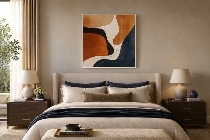 Mid Century Modern abstract square canvas art with navy and earth tone organic shapes over a bed.