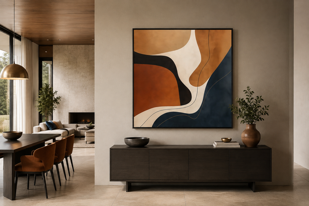 Square canvas wall art with abstract organic shapes in navy, rust, and cream above a dark sideboard.