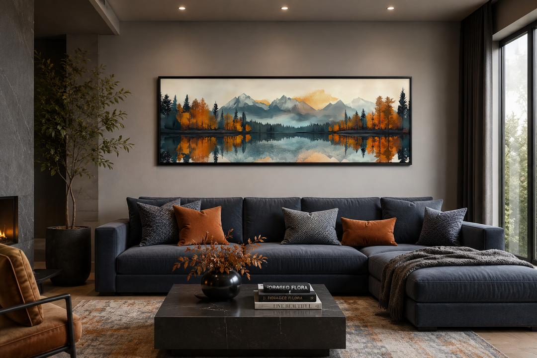 Long narrow canvas wall art of a mid-century modern mountain lake landscape above a navy blue sofa.