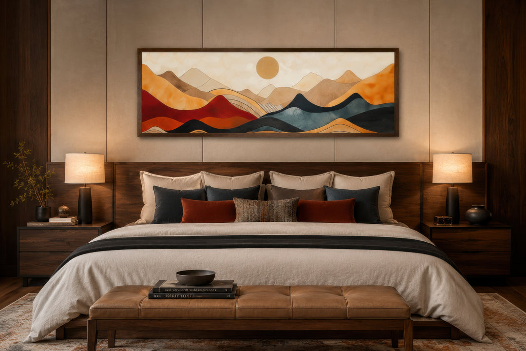 Mid-century modern horizontal mountain canvas wall art in a dark wood frame above a bed.