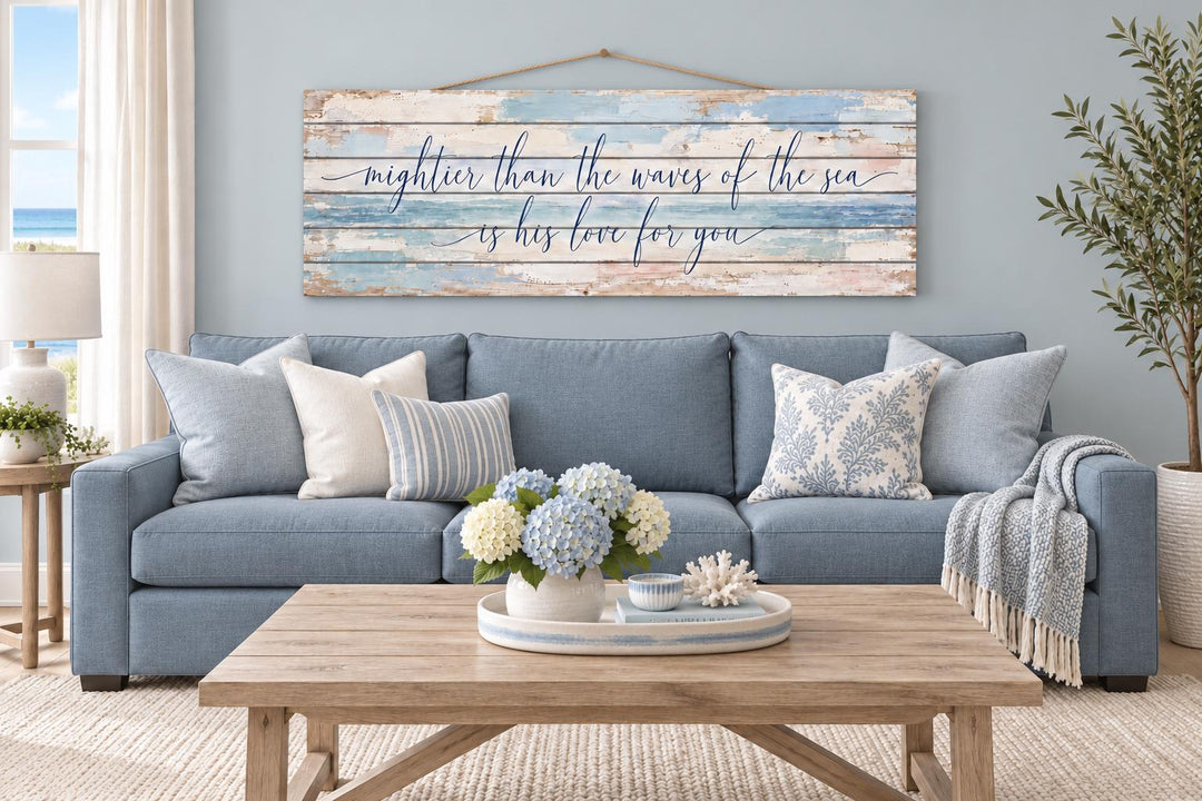 Mightier Than the Waves of the Sea distressed wood wall art hanging above a blue sofa.