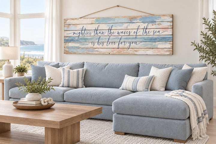 Mightier Than the Waves of the Sea distressed wood wall art above a blue sectional sofa.