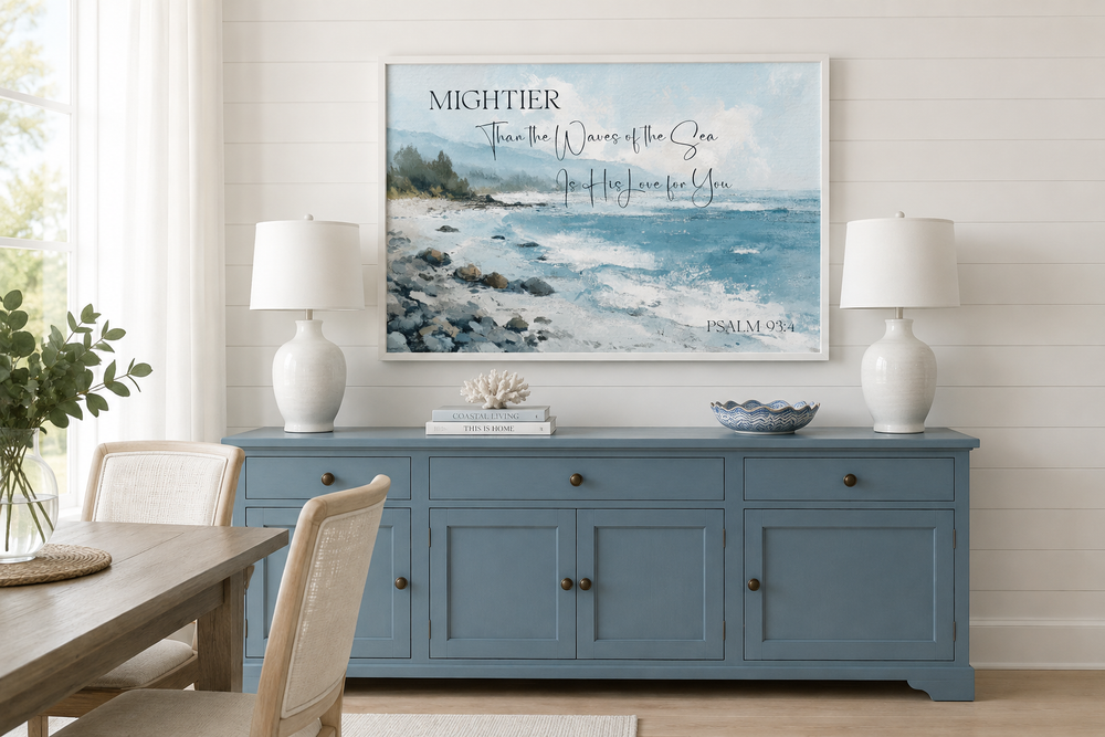 Psalm 93:4 coastal wall art featuring a textured ocean painting above a blue sideboard.