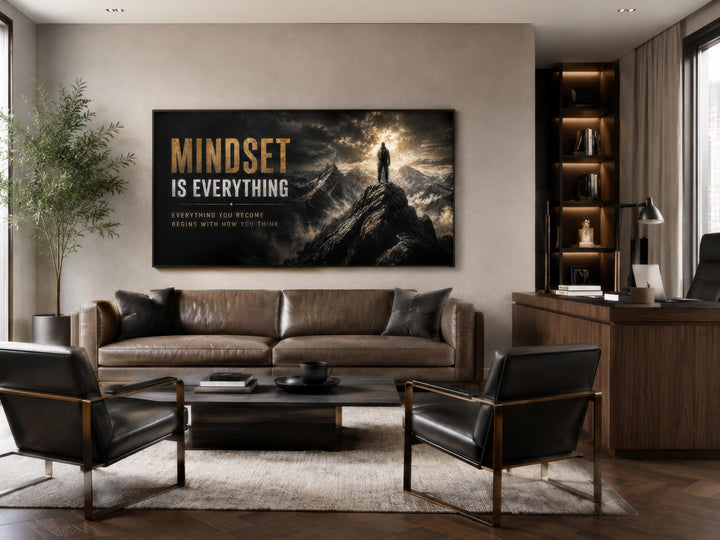 Mindset Is Everything black and gold canvas wall art in a modern office above a leather sofa.
