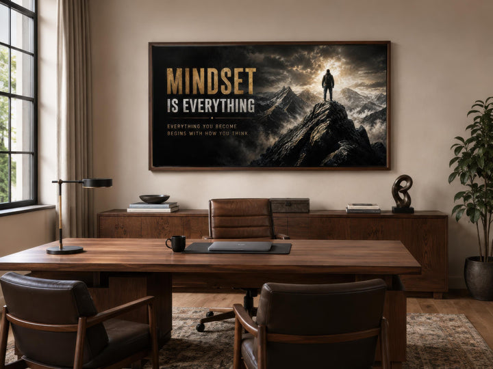 Mindset Is Everything black and gold motivational canvas art above a desk in a modern office.
