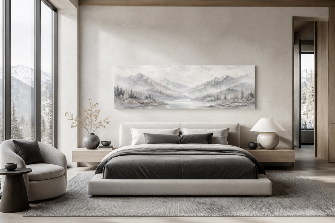 Minimalist abstract mountain panoramic wall art in grey, silver, and white above a modern bed.