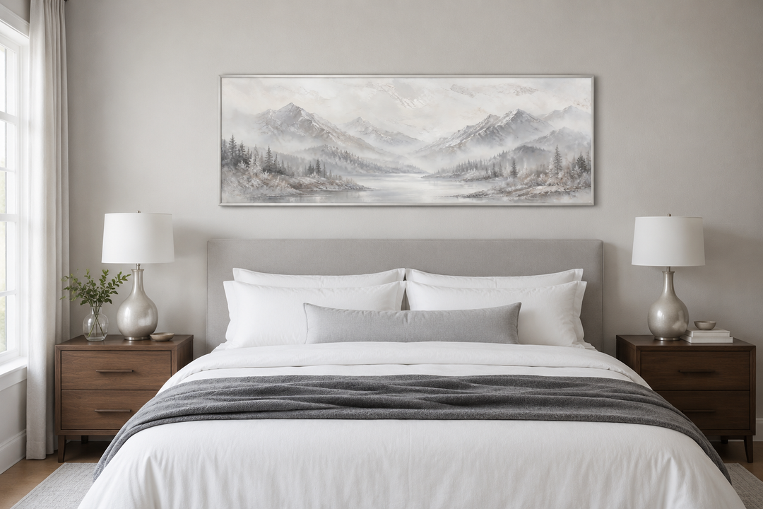 Minimalist abstract mountain panoramic wall art in grey and silver hanging over a bed.