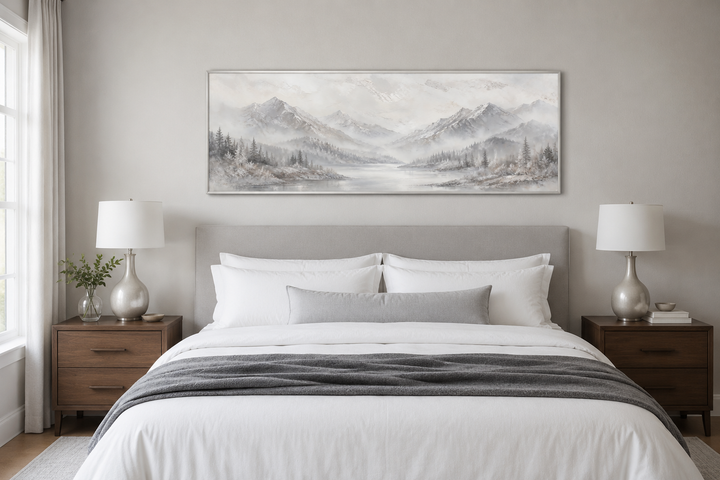 Minimalist abstract mountain panoramic wall art in grey and silver hanging over a bed.