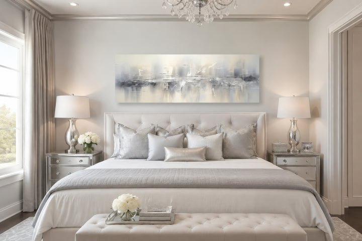 Minimalist abstract silver gray long horizontal framed canvas wall art hanging above a bed.