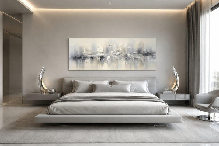 Minimalist abstract silver gray long horizontal framed canvas wall art above a modern bed.