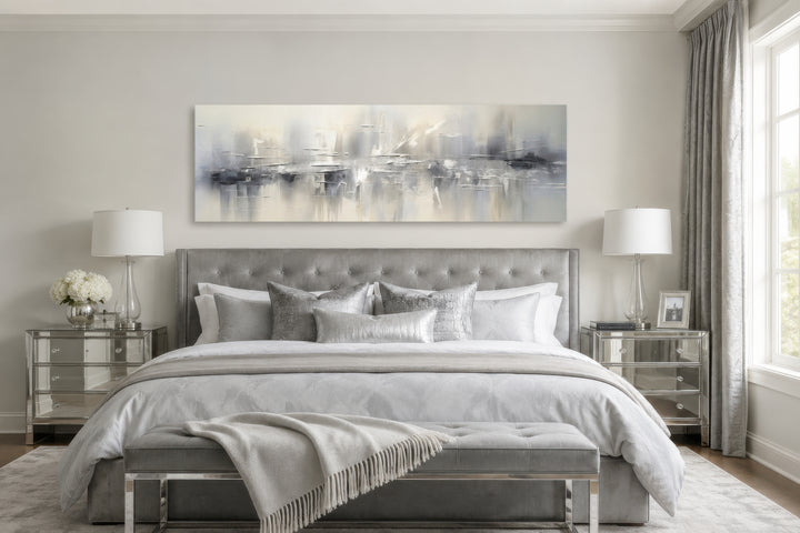 Minimalist abstract silver gray long horizontal framed canvas wall art above a bed.