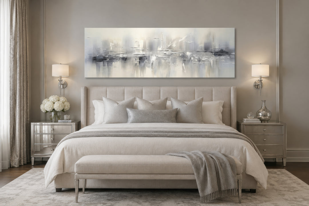 Minimalist abstract silver gray long horizontal framed canvas wall art hanging above a bed.