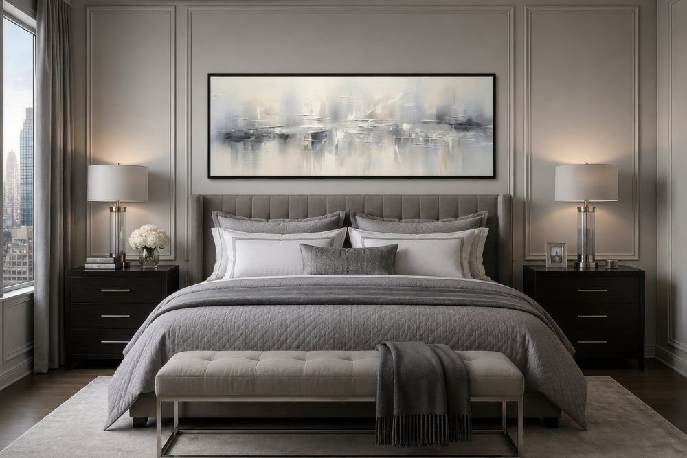 Minimalist abstract silver gray long horizontal framed canvas wall art hanging above a bed.