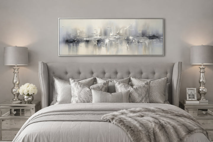 Minimalist abstract silver gray long horizontal framed canvas wall art hanging above a bed.