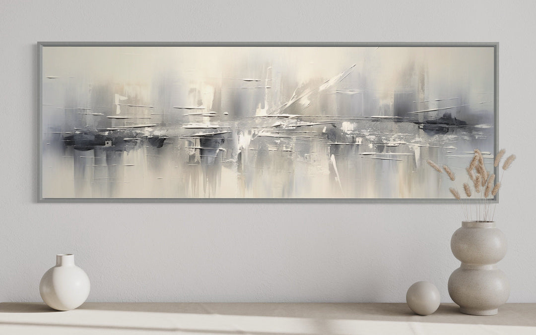 Minimalist abstract silver gray long horizontal framed canvas wall art in a modern living room.