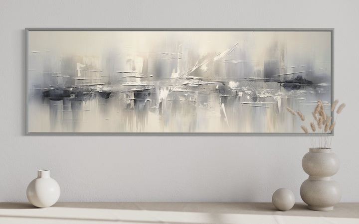 Minimalist abstract silver gray long horizontal framed canvas wall art in a modern living room.