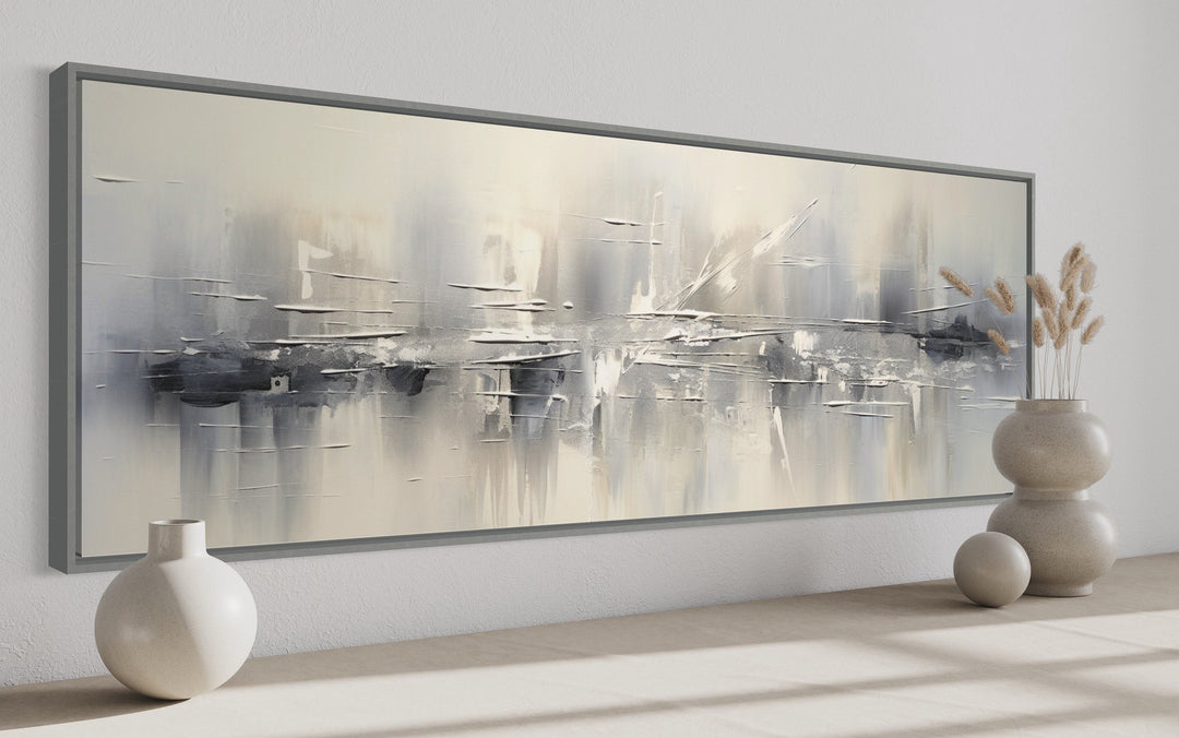 Minimalist abstract silver gray long horizontal framed canvas wall art in a modern room setting.