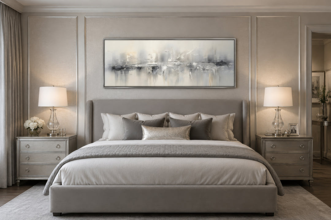 Minimalist abstract silver gray long horizontal framed canvas wall art hanging above a bed.