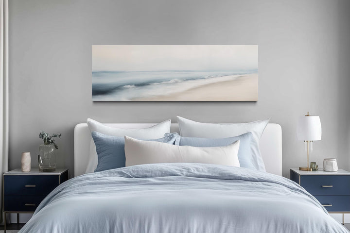 Minimalist panoramic watercolor ocean beach wall art in a serene bedroom setting.