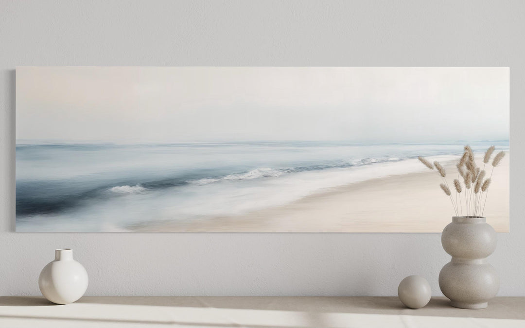 Minimalist panoramic coastal wall art featuring a soft watercolor seascape in gray and blue tones.