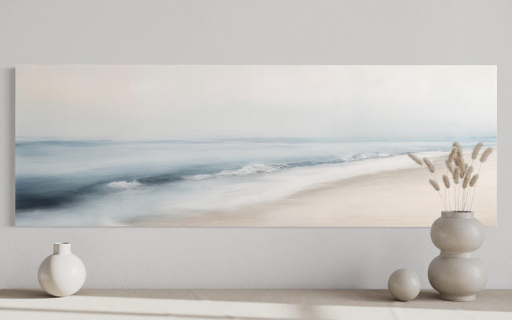 Minimalist panoramic coastal wall art featuring a soft watercolor seascape in gray and blue tones.