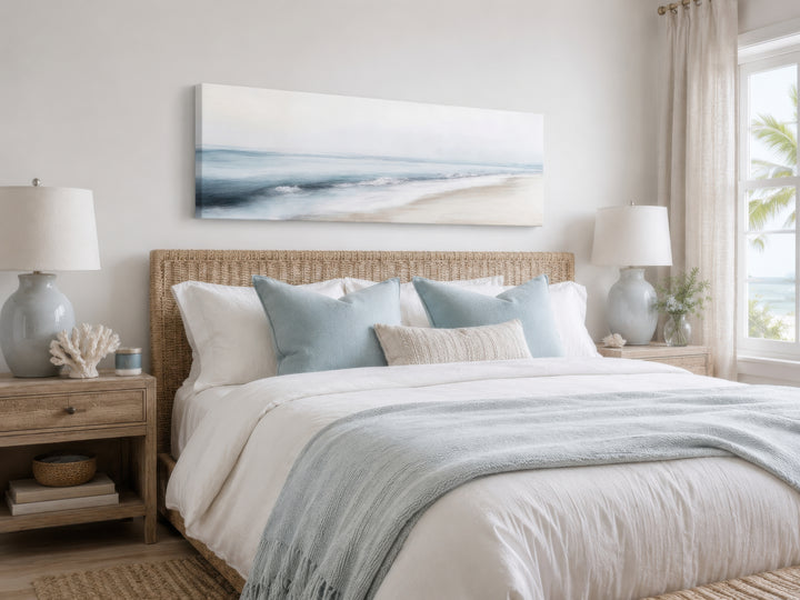 Minimalist panoramic watercolor painting of a calm gray and blue ocean beach over a bed.