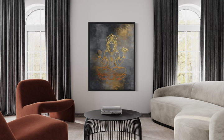 Minimalist Lakshmi gold and silver framed canvas wall art in a modern living room setting.