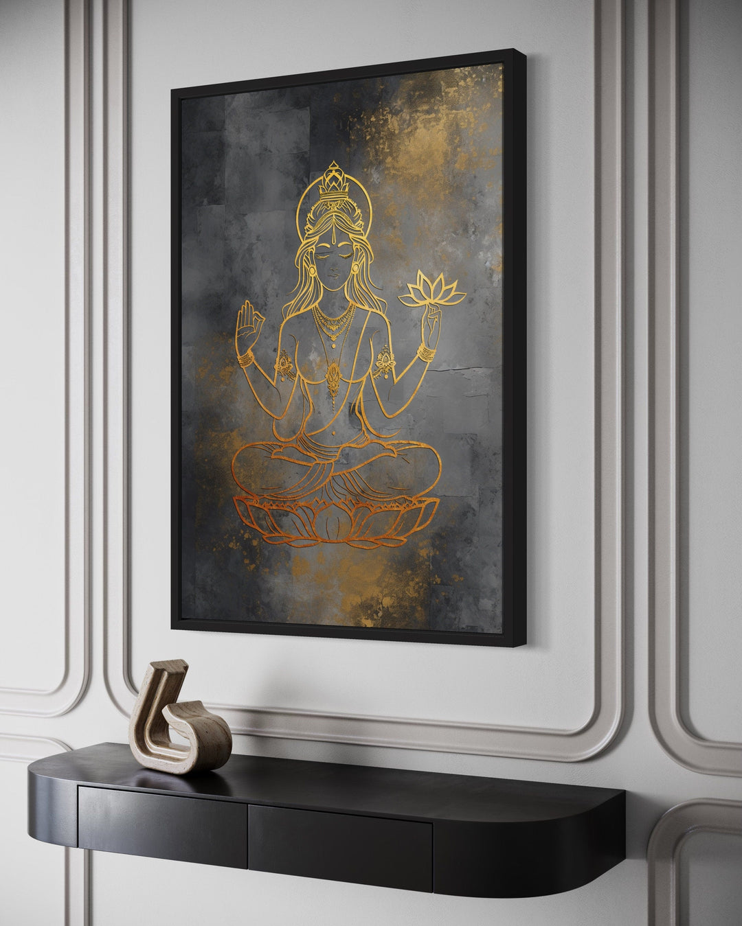 Minimalist gold Lakshmi goddess line art on a dark gray textured framed canvas above a black console.