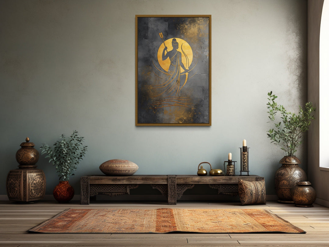 Minimalist Lord Rama framed canvas wall art in gold and silver tones above a rustic wooden bench.