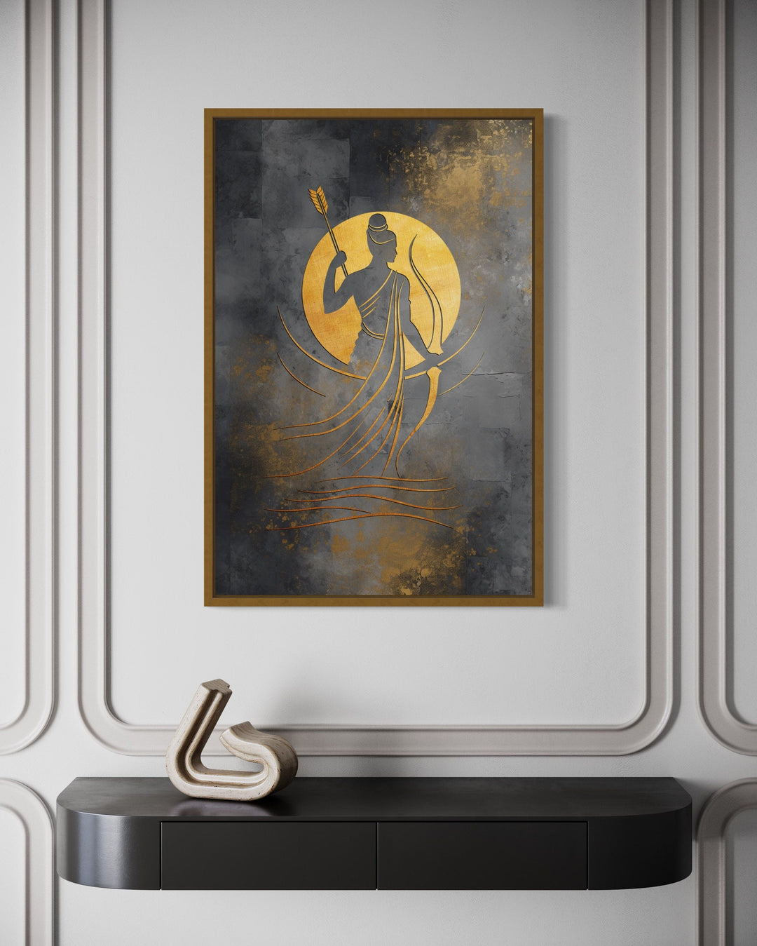 Minimalist Lord Rama wall art in gold and silver tones, framed on a white paneled wall.