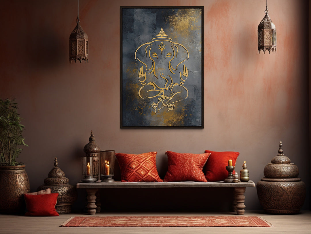 Minimalist gold Lord Ganesha line art on a dark gray framed canvas in a warm, rustic room setting.