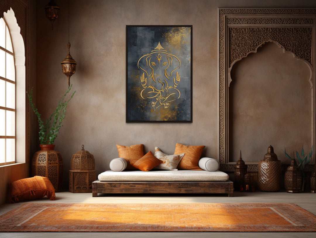 Minimalist gold Lord Ganesha line art on a dark gray framed canvas in a modern Indian living room.