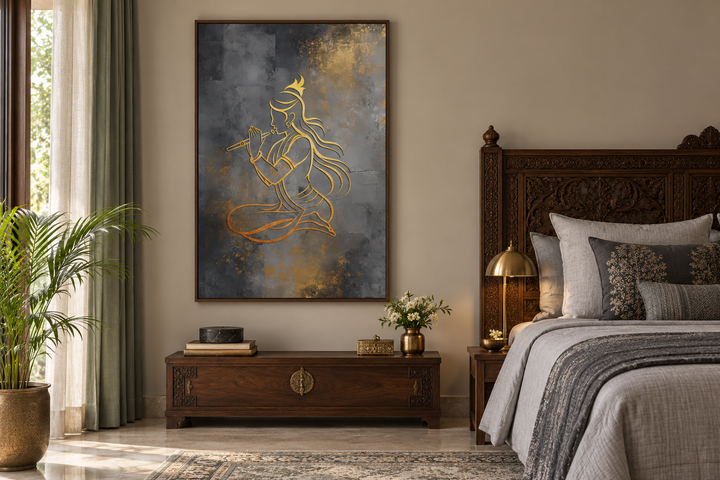 Minimalist gold Lord Krishna with flute framed canvas wall art above a dark wood chest in a bedroom.