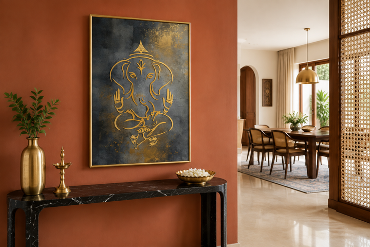 Minimalist gold Lord Ganesha framed canvas wall art on a terracotta wall above a black console table.